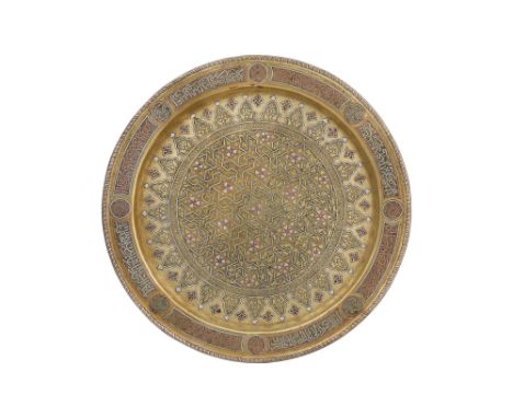 A DAMASCUS-WARE SILVER AND COPPER-INLAID BRASS DISH WITH STELLAR AND FLORAL DECORATION Damascus, Syria, circa 1900A large cir