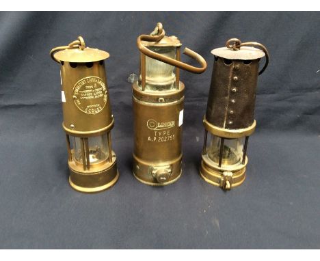 A 19th century miners lamp made in Newcastle upon Tyne, together with an Oldham type A.P. 202755 early 20th century lamp, and