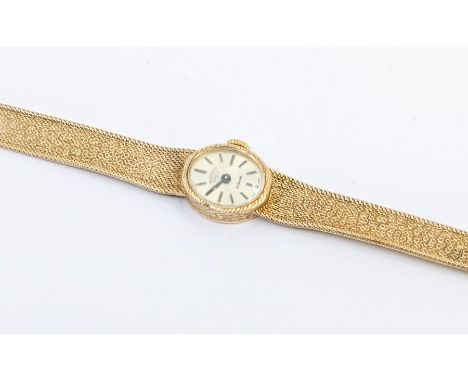 A ladies 9ct gold Rotary wristwatch, oval silvered dial, baton markers, to an integral 9ct gold textured bracelet, total gros