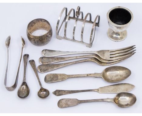 A collection of silver to include: a Birmingham silver four slot toast rack, a Birmingham silver surrounded early plastic egg