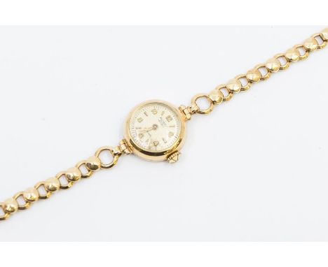 A ladies early 20th century 9ct gold Rotary wristwatch, comprising a signed  round champagne dial with applied gilt baton and