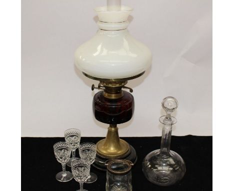 A late 19th century decanter, glasses, a small glass decanter and ruby glass, late 19th century oil lamp