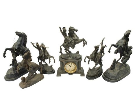 An early 20th century French spelter mantel clock with garnitures and Roman figure detail together with Coulson-style firesid