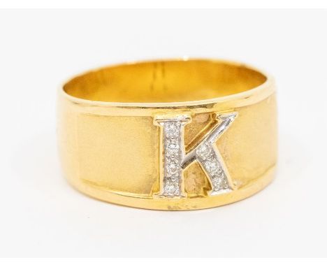 A diamond set 18ct gold initial ring, comprising a band, with an applied initial 'K' set with small diamonds, width approx 12