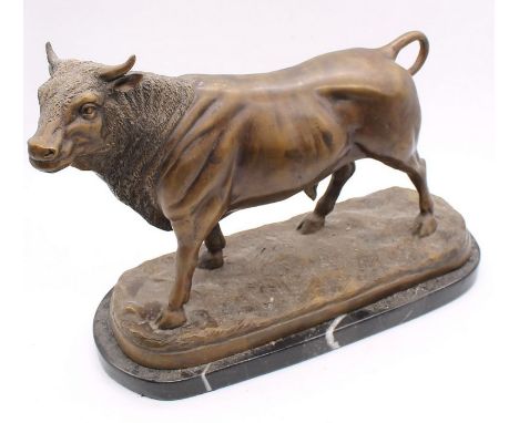 A bronze figure of a bull, on marble stand