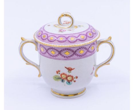 A Chelsea porcelain Chocolate cup and cover, gold anchor, the two handled cup decorated with pink roses, primroses and floral