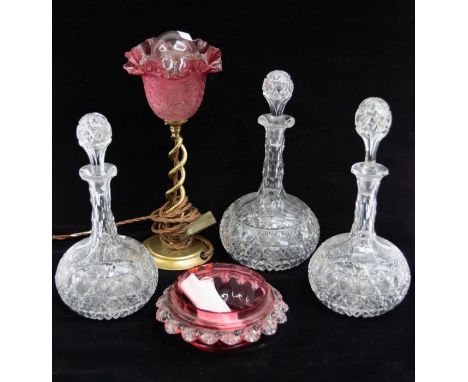 Two large and one small Victorian glass globe decanters, together with a ruby glass dish and a table lamp