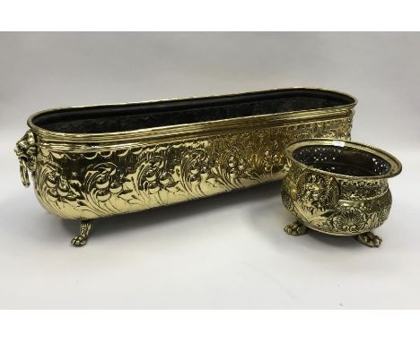 A large 19th century rectangular brass planter, with lion mask and ring handles.Profusely decorated to the body in the repous