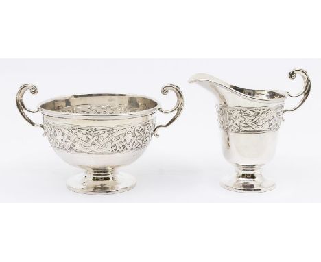 A George V silver two handled sugar bowl on circular pedestal base and with embossed Celtic pattern design to body, hallmarke