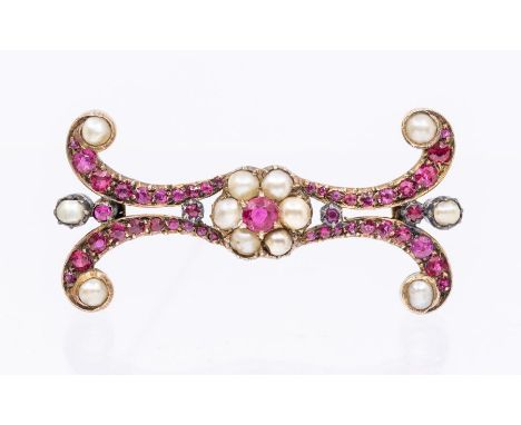 An early 20th century ruby and pearl set gold brooch, comprising a central flower motif set to the centre with a round mixed 