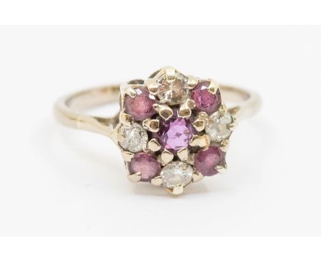 A ruby and diamond set white gold cluster ring, comprising five round mixed cut rubies and three round brilliant cut diamonds