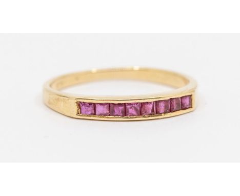 A ruby and 14ct gold half eternity ring, channel set with eight calibre cut rubies each approx 1.2mm, size O, total gross wei