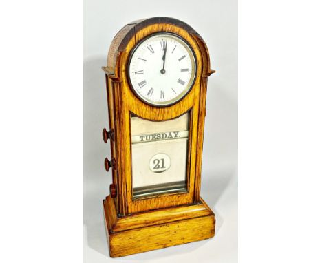 A late Victorian / Edwardian oak cased table clock/calendar, 3.5” dial, 34cm high.