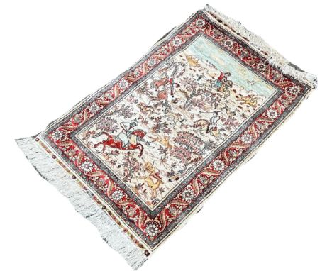 A Persian silk rug with  a hunting scene possibly Isfahan 92cm x 65cm 