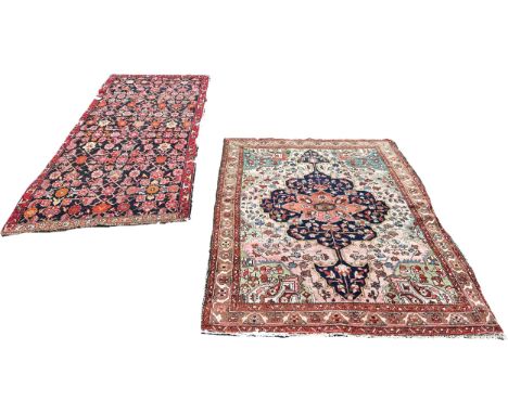 A Tree of Life Middle Eastern type carpet with floral sprays on a pink ground together with an old Middle Eastern runner with
