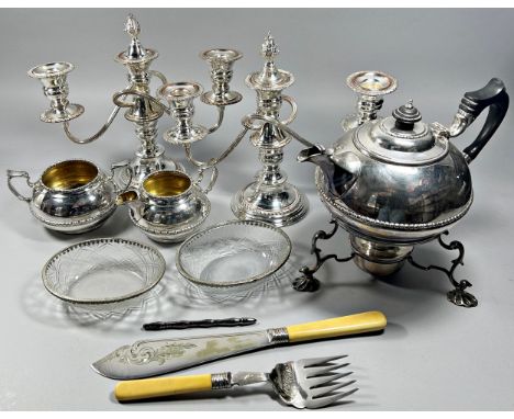 A large collection of silver plated ware to include tea service and burner, candelabra, flatware and dishes
