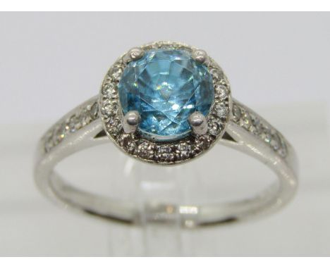 950 platinum blue topaz and diamond halo cluster ring, the diamonds 0.02ct each approx, maker 'XM', Birmingham (no date lette
