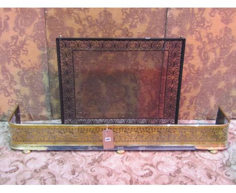 A polished brass fire fender with decorative pierced fretwork grill, 18 cm high x 130 cm together with an iron fire guard/scr