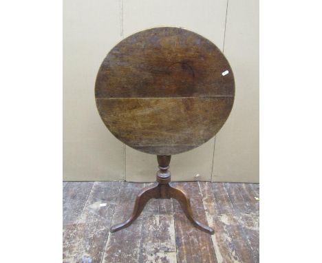 A Georgian oak country made snap top table on turned pillar and tripod, the top 69cm diameter