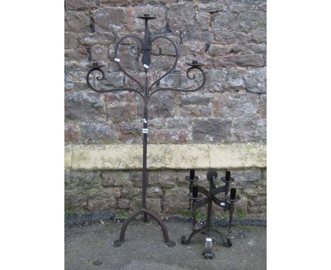 An ironwork floorstanding three branch candelabra with open scroll detail, 120 cm high, together with a further light fitting