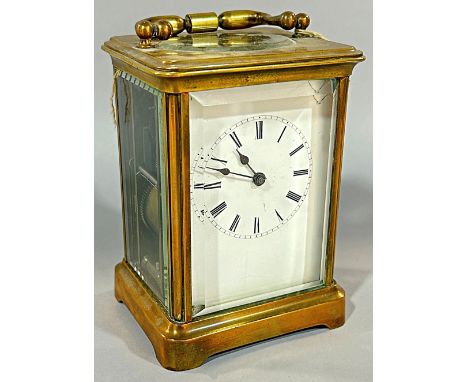 A small brass cased carriage clock with white enamelled dial, 13cm high.