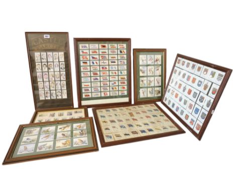 A group of seven framed sets of cigarette cards, to include: National flags and coats of arms; British and exotic birds, and 