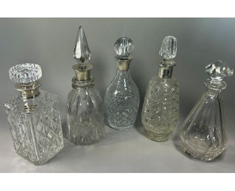 Three silver collar cut glass decanters, together with a Moser cut glass decanter and one other (5)