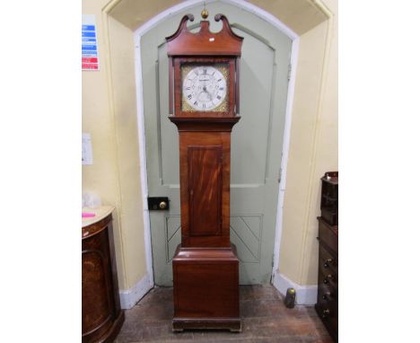 A Regency mahogany longcase clock enclosing a square brass dial with silvered chapter ring and centre with engraved detail, c
