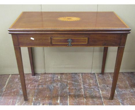 A Georgian mahogany fold over top card table of rectangular form, the circular baize lined interior with dished corners, encl