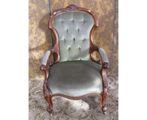 A Victorian drawing room chair with upholstered seat and button back with show wood frame 