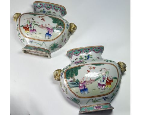 A pair of Chinese famille rose wall mounted vases painted with three boys playing in a garden and floral decorations, with gi