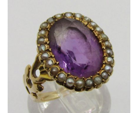 Antique yellow metal amethyst and seed pearl oval cluster ring with pierced shoulders, size J, 4.8g