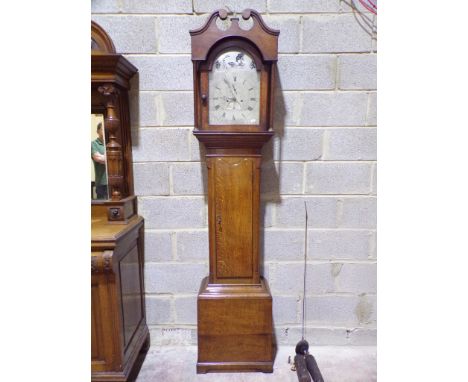 A Georgian oak longcase clock with broken arch silvered dial, subsidiary calendar and secondary dials and eight day striking 