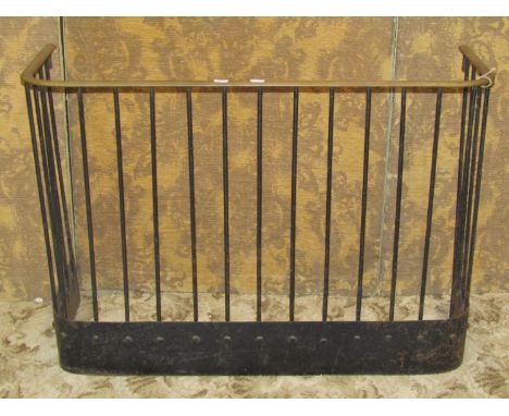 A 19th century iron work fire fender/guard with simple open vertical bars supporting a brass rail, 62 cm high x 88 cm x 30 cm