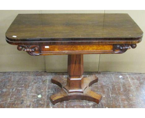 A Regency rosewood D-end fold over top card table, raised on a tapering column and platform base, 91cm wide