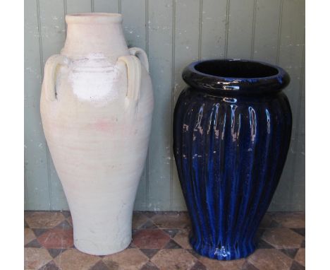 A Mediterranean terracotta jar with moulded loop handles, 83 cm high, together with a contemporary dark blue glazed planter 6