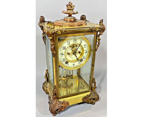 A 19th century four pane table clock, the chapter ring with black Arabic numerals above mercury pendulum, with cast metal mou