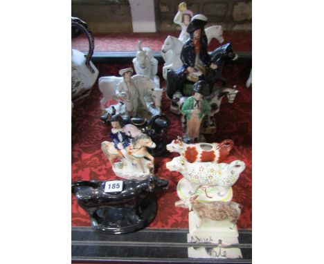 A collection of 19th century Staffordshire flatback figures including Dick Turpin and Tom King, farmer and cow, four cow crea