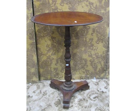 A 19th century rosewood occasional table with associated oval mahogany top raised on a turned and carved pillar set on a tric