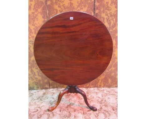 A Georgian mahogany snap top table of circular form, the one piece top 90cm approx diameter, raised on a turned pillar and tr