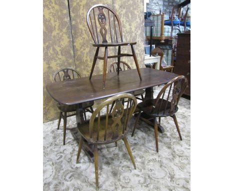 A vintage Ercol dark stained elm refectory table together with a set of six associated Ercol hoop and stick back dining chair