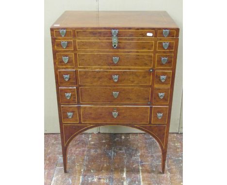 A pretty Georgian mahogany commode with rising lid over a central cupboard and single long frieze drawer, accompanied by four