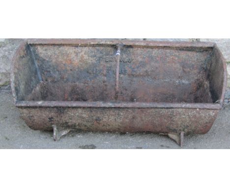 A vintage cast iron feeding trough with simple rung division stamped Eaton &amp; Co Market Harborough, 32 cm high x 81 cm x 3