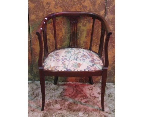 An Edwardian mahogany light weight tub chair, the horseshoe shaped back with pierced splats and upholstered pad seat