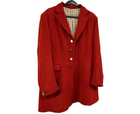 A red wool hunting jacket, made by Saddle Master, a pair of black leather riding boots with wooden trees, a riding helmet, a 