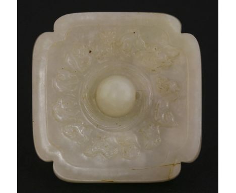 A white jade Appliqué or Pendant,18th century, in the form of a Ming mirror, the central pierced boss within a twist torque, 