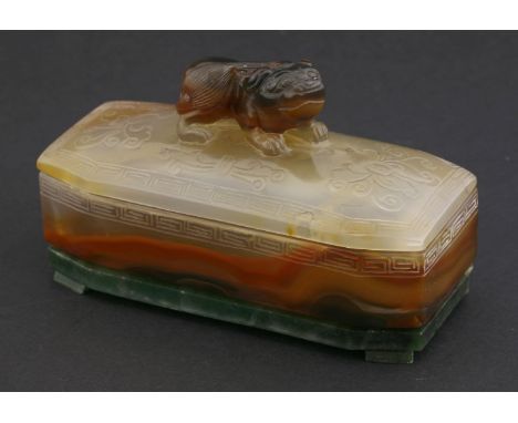 A jade Box, Cover and Stand,20th century, the rounded rectangular body with engraved key fret border, artificially stained as