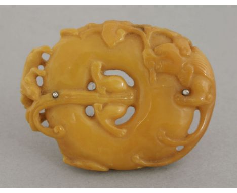 An amber Brooch, 19th century, pierced and carved as a ring around which crawl chilong with lingzhi, the amber of even yellow