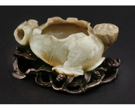 A jade Brush Washer, 20th century, carved in the form of a large lotus flower, surrounded by two others, a seed pod and a cla