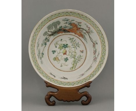 A famille rose Wash Basin,c.1930, the deep well with red rocks, willow, prunus and two magpies surrounding lychee and bamboo,